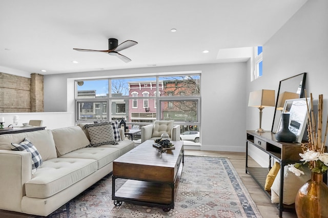 living area with light wood-type flooring, baseboards, a wealth of natural light, and recessed lighting