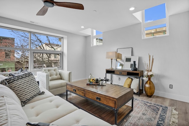 living area with baseboards, visible vents, ceiling fan, wood finished floors, and recessed lighting