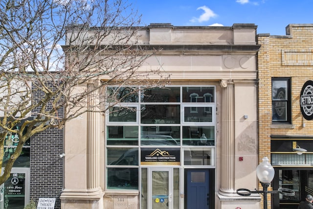 property entrance featuring brick siding