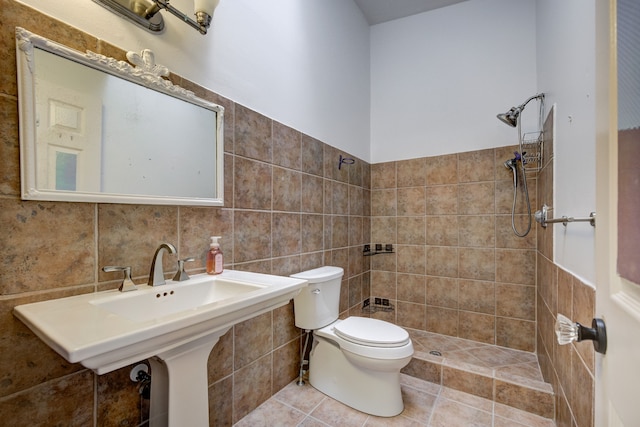 bathroom with tile patterned floors, tile walls, toilet, and walk in shower