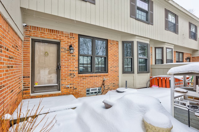 view of snow covered property entrance