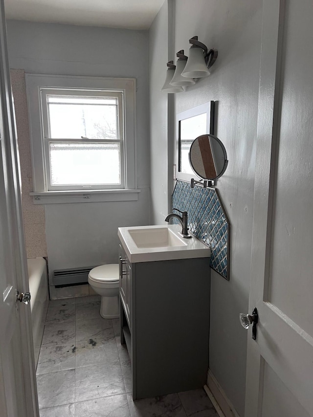 bathroom with a baseboard radiator, vanity, and toilet