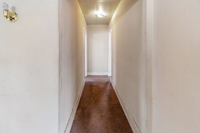 hall with carpet flooring and baseboards