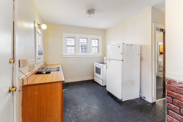 kitchen with baseboards, dark floors, light countertops, white appliances, and a sink