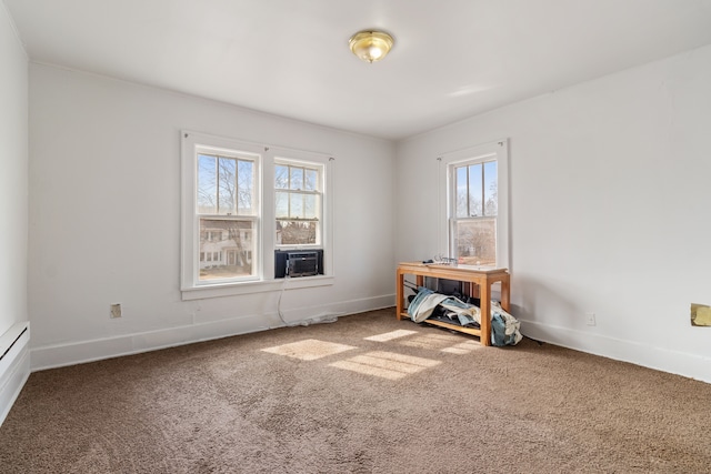 carpeted empty room featuring baseboards and plenty of natural light