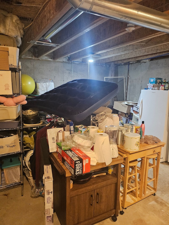 basement with white fridge