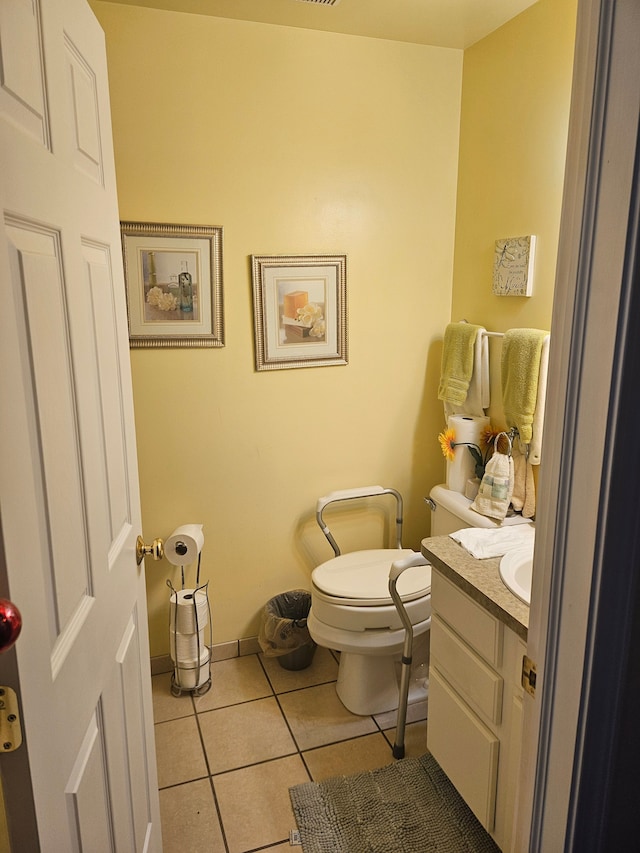 bathroom with toilet, tile patterned flooring, and vanity