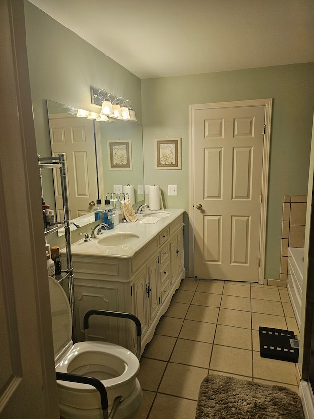 bathroom with tile patterned flooring, vanity, and a bathing tub