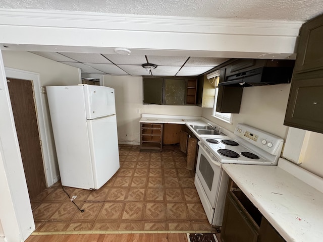 kitchen featuring a paneled ceiling, white appliances, a sink, light countertops, and dark brown cabinets