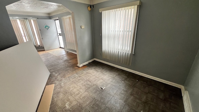 foyer entrance with a textured ceiling