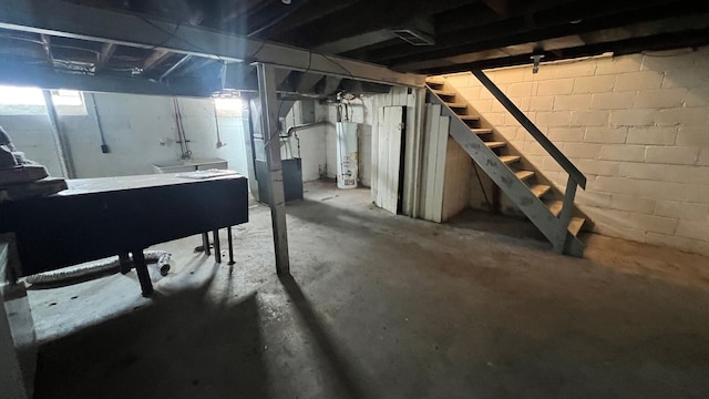 basement featuring water heater and heating unit