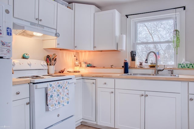 kitchen with sink, white electric range oven, and white cabinets