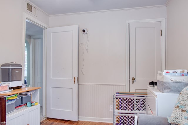 interior space with crown molding and light hardwood / wood-style floors