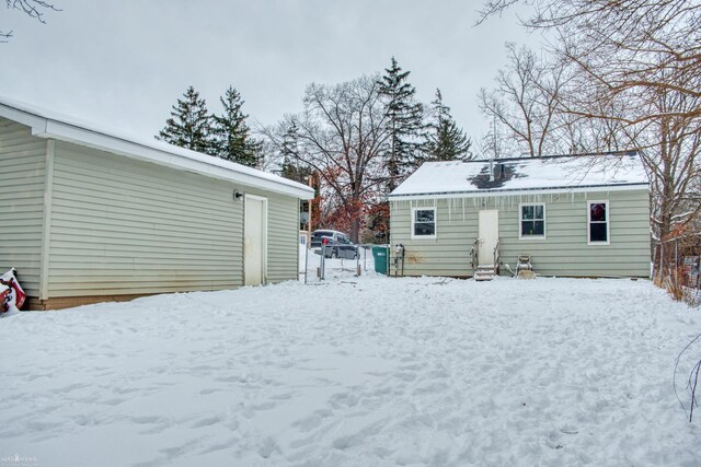 view of snow covered rear of property