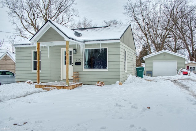 bungalow featuring a garage and an outdoor structure