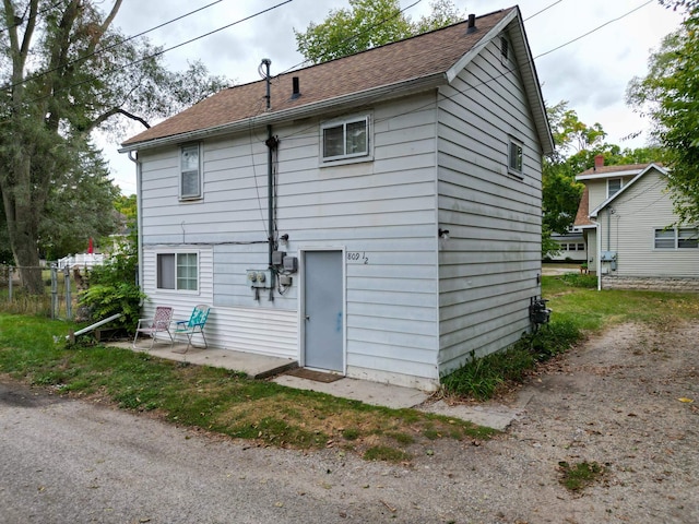 rear view of property featuring fence and a patio