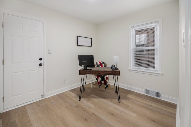 office featuring light wood-style floors, visible vents, and baseboards