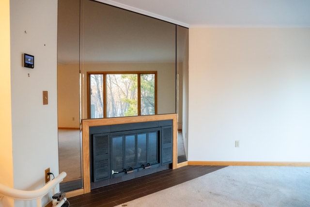 living room featuring dark hardwood / wood-style flooring and ornamental molding