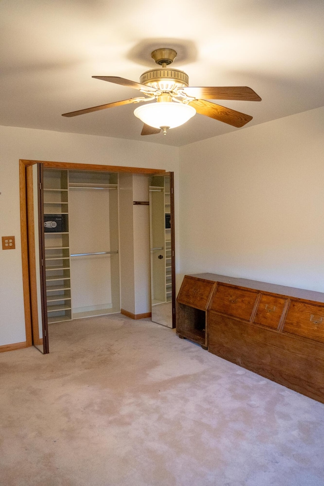 unfurnished bedroom with carpet flooring, ceiling fan, and a closet