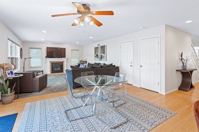 dining room with light hardwood / wood-style flooring and ceiling fan