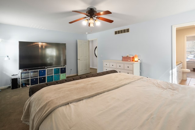 bedroom featuring ceiling fan, carpet, and ensuite bathroom