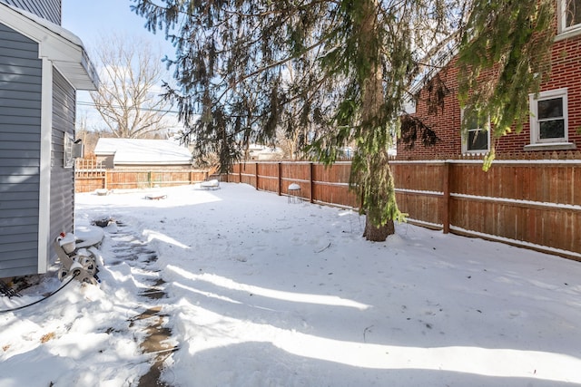 view of yard layered in snow