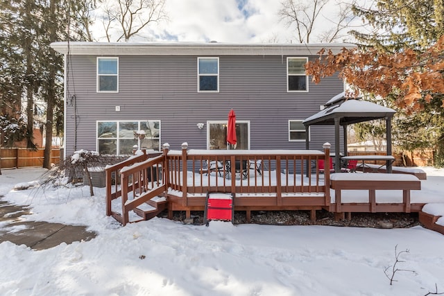 snow covered property featuring a deck