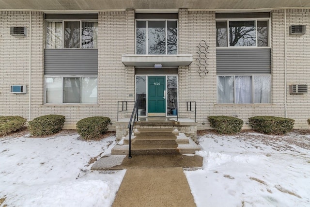 view of snow covered property entrance