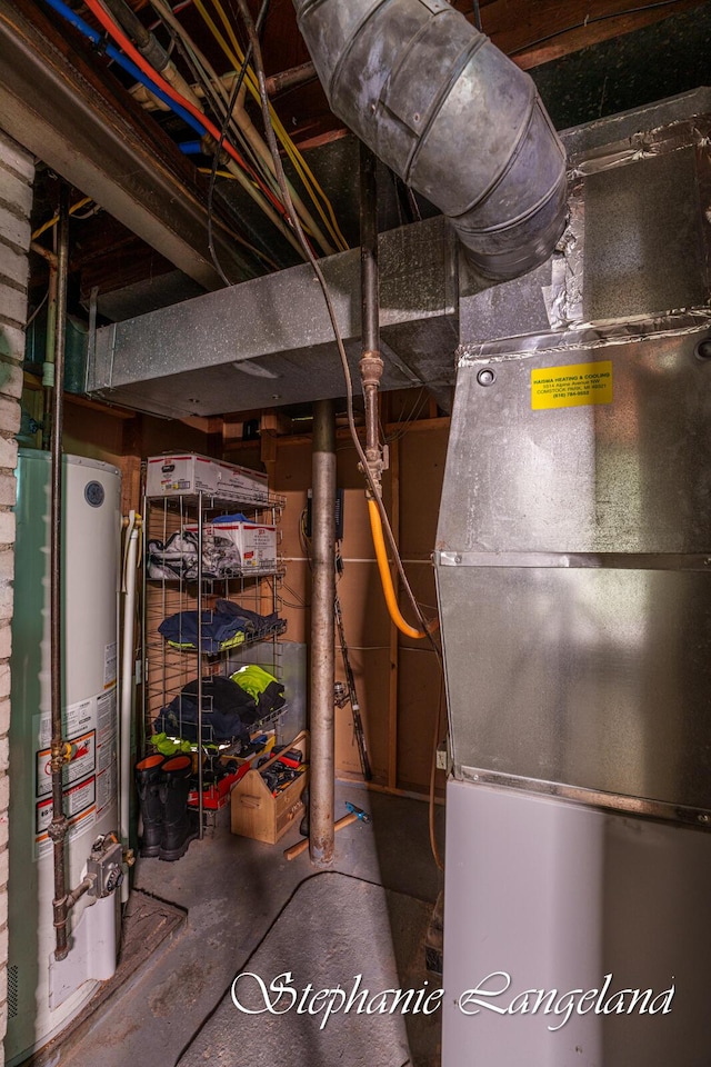 utility room featuring water heater