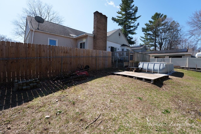 view of yard with a fenced backyard and a wooden deck