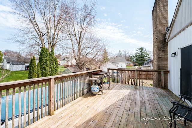 deck with an outdoor structure and a residential view