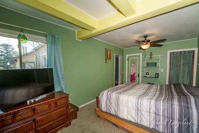 carpeted bedroom with beamed ceiling, baseboards, and ceiling fan