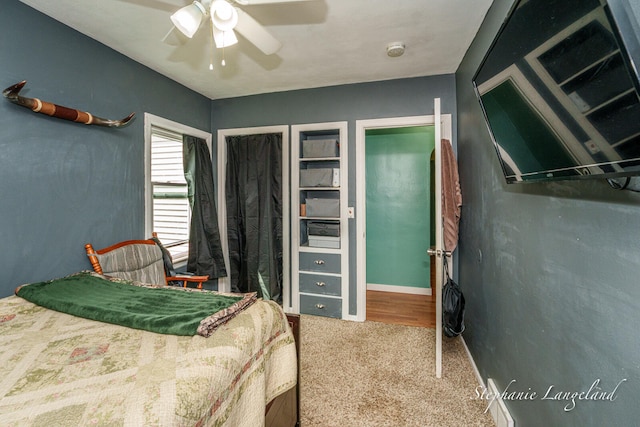 carpeted bedroom with a ceiling fan and baseboards