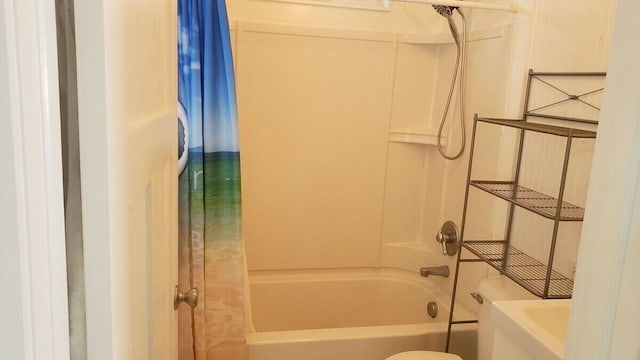 bathroom featuring shower / tub combo with curtain and toilet