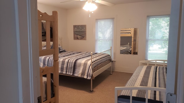 bedroom featuring ceiling fan and carpet