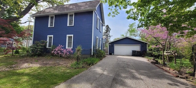 view of front of property featuring a garage and an outdoor structure