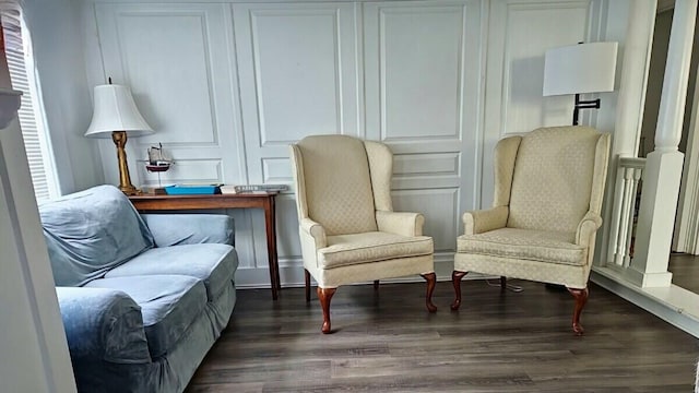 sitting room featuring dark wood-type flooring