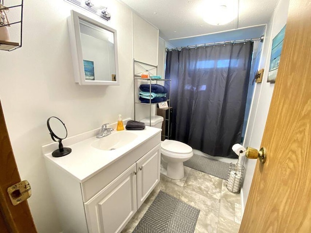 bathroom featuring vanity, curtained shower, and toilet