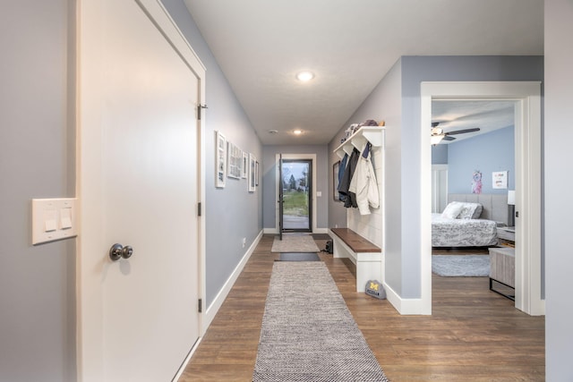 interior space with ceiling fan and wood-type flooring