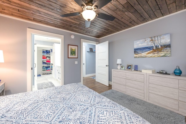 bedroom featuring crown molding, ceiling fan, a spacious closet, and wooden ceiling