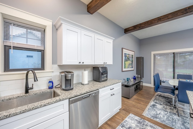 kitchen with sink, stainless steel dishwasher, white cabinets, and light stone counters