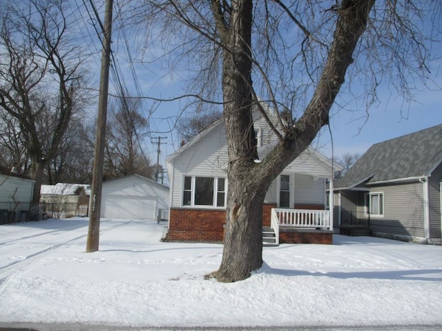 view of front of home with an outbuilding, a porch, and a garage