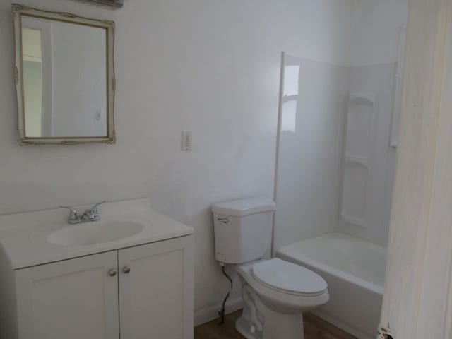 full bathroom featuring vanity, toilet, tub / shower combination, and wood-type flooring