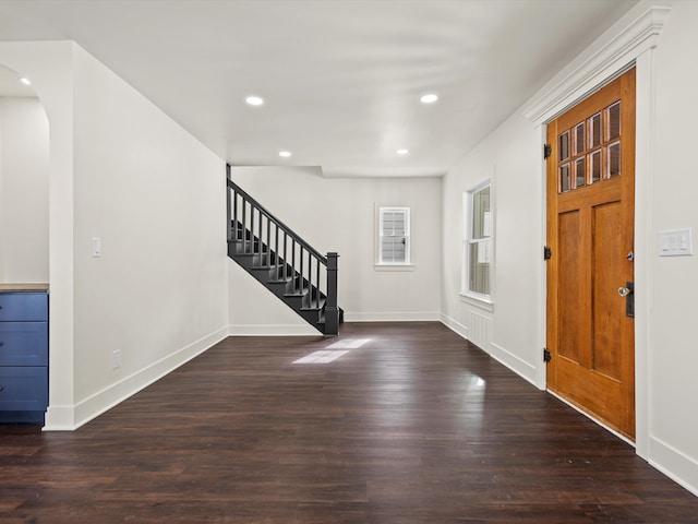 entrance foyer with baseboards, arched walkways, stairway, wood finished floors, and recessed lighting