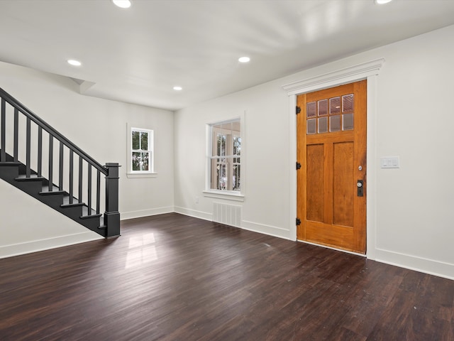 entryway with stairs, wood finished floors, and baseboards