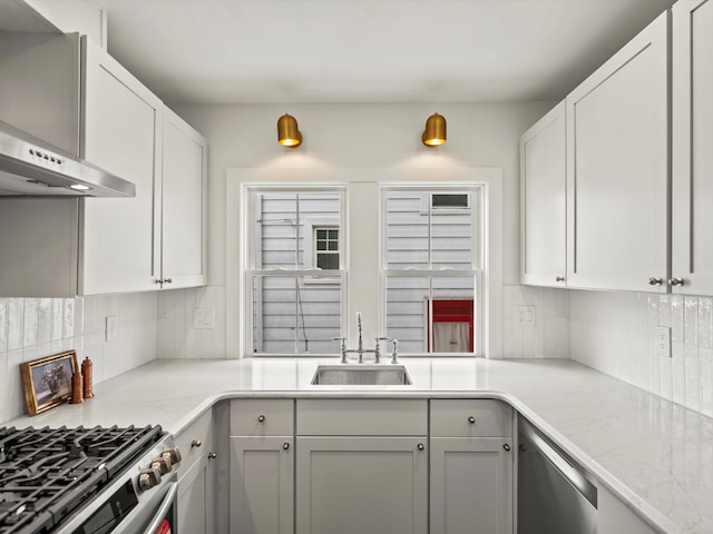 kitchen featuring dishwasher, backsplash, a sink, and range hood