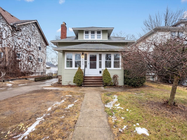 bungalow-style home featuring entry steps and a chimney