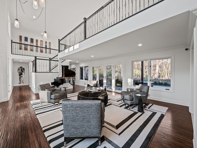 living room with ornamental molding, wood finished floors, and baseboards