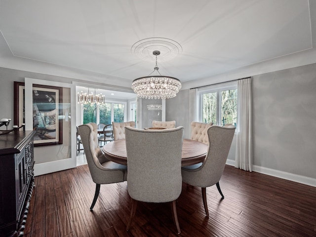 dining space with baseboards, dark wood-style flooring, and a notable chandelier