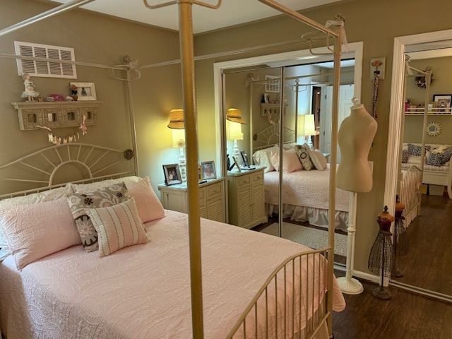 bedroom featuring visible vents and wood finished floors